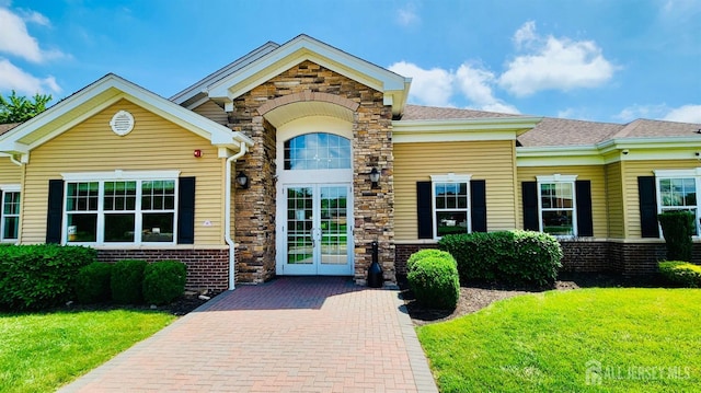 548 E Celebration Way E, South Plainfield, NJ 07080 - doorway to property featuring a lawn, stone siding, a shingled roof, and brick siding