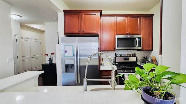 548 E Celebration Way E, South Plainfield, NJ 07080 - kitchen with stainless steel appliances, dark brown cabinets, and decorative backsplash