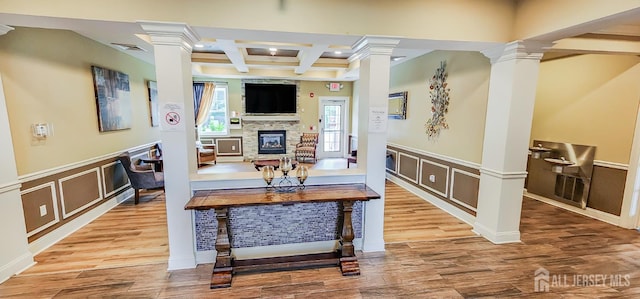 548 E Celebration Way E, South Plainfield, NJ 07080 - living area featuring ornate columns, coffered ceiling, a stone fireplace, a decorative wall, and beamed ceiling