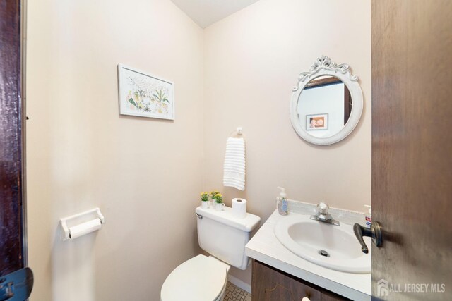 77 Highview Dr, Woodbridge Proper, NJ 07095 - half bathroom featuring toilet, vanity, and tile patterned flooring