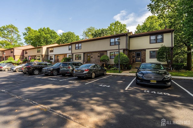 77 Highview Dr, Woodbridge Proper, NJ 07095 - view of front facade featuring uncovered parking and brick siding