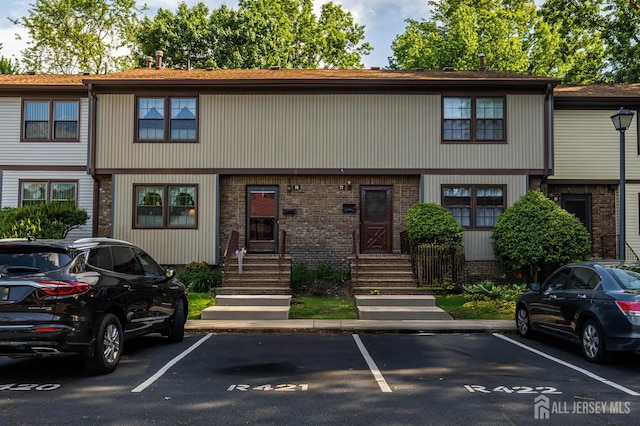 77 Highview Dr, Woodbridge Proper, NJ 07095 - townhome / multi-family property featuring uncovered parking, brick siding, and entry steps