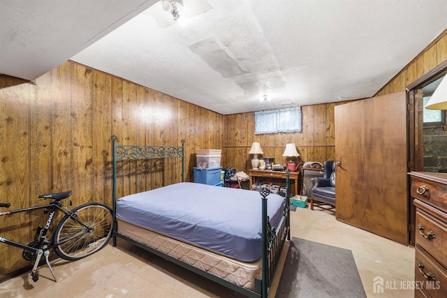 77 Highview Dr, Woodbridge Proper, NJ 07095 - bedroom featuring finished concrete floors and wooden walls