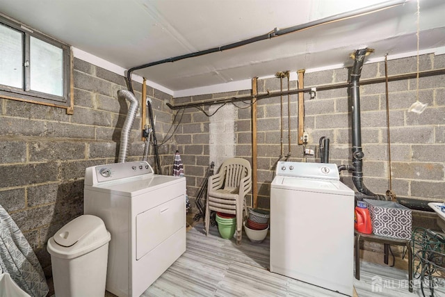 77 Highview Dr, Woodbridge Proper, NJ 07095 - laundry room featuring washing machine and clothes dryer, concrete block wall, and light wood-style flooring