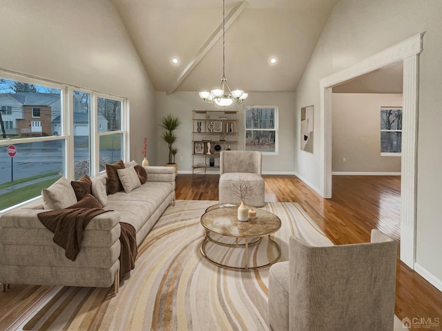 living room with high vaulted ceiling, wood finished floors, recessed lighting, an inviting chandelier, and baseboards