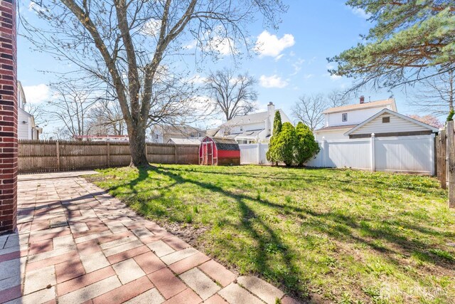 43 Jensen Ave, Fords, NJ 08863 - view of yard with a fenced backyard, a patio area, a shed, and an outbuilding