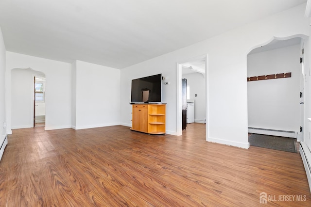 43 Jensen Ave, Fords, NJ 08863 - unfurnished living room featuring baseboards, a baseboard radiator, arched walkways, and wood finished floors