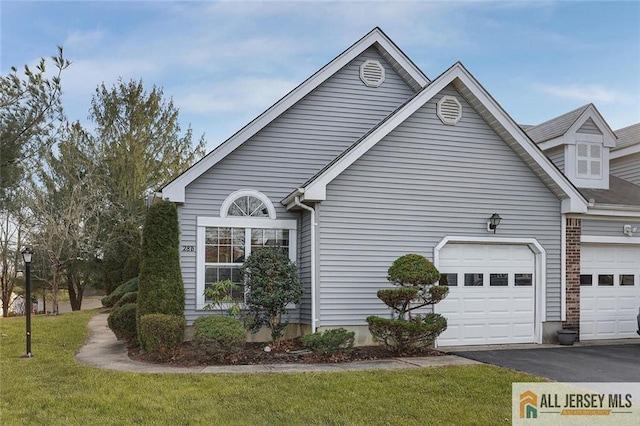 view of property exterior featuring driveway, an attached garage, a lawn, and brick siding