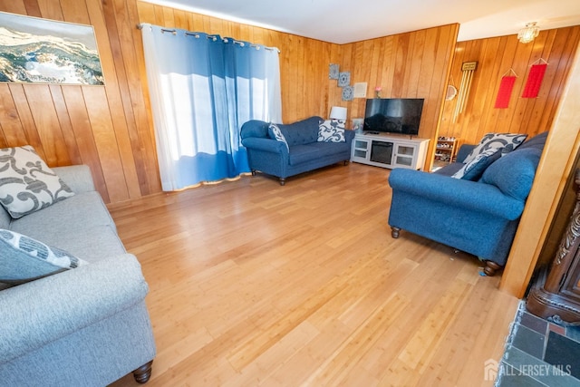 living area with wooden walls and wood finished floors