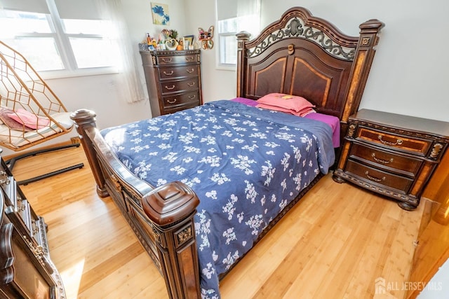 bedroom featuring multiple windows and wood finished floors