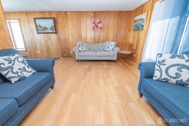 living room with wood finished floors and wooden walls