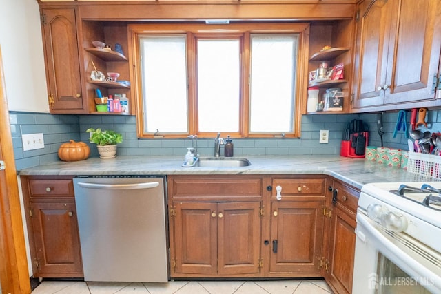 kitchen featuring a sink, stainless steel dishwasher, open shelves, brown cabinetry, and plenty of natural light