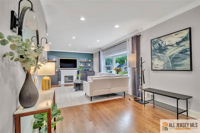 27 Collins Rd, Hamilton, NJ 08619 - living room with ornamental molding, recessed lighting, wood finished floors, and a glass covered fireplace