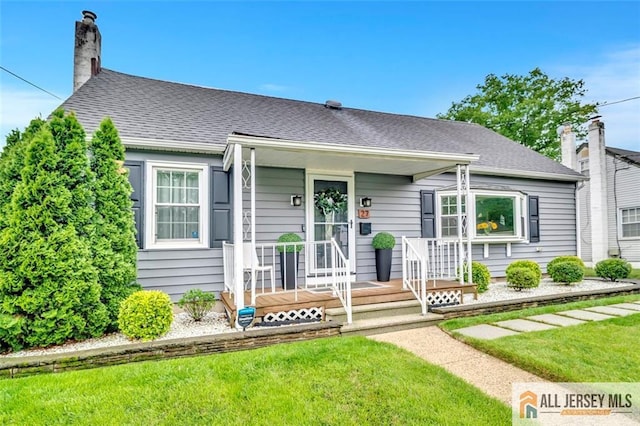 27 Collins Rd, Hamilton, NJ 08619 - view of front of property with a front yard, a chimney, roof with shingles, and covered porch