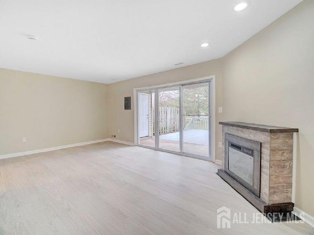 308 Pewter Ct, Old Bridge, NJ 08857 - unfurnished living room with light wood-style flooring, a glass covered fireplace, baseboards, and recessed lighting