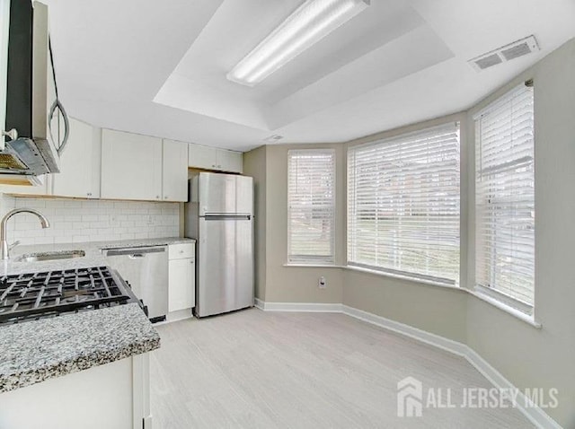308 Pewter Ct, Old Bridge, NJ 08857 - kitchen featuring appliances with stainless steel finishes, a sink, baseboards, white cabinetry, and tasteful backsplash