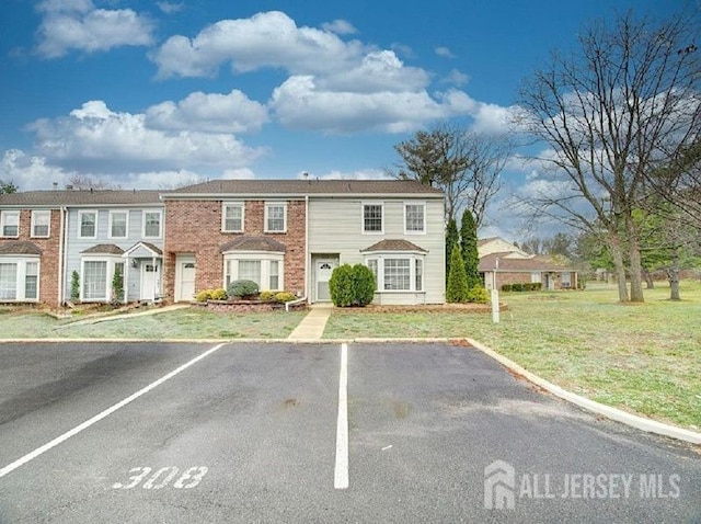 308 Pewter Ct, Old Bridge, NJ 08857 - townhome / multi-family property with uncovered parking, a front lawn, and brick siding