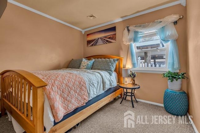 bedroom with crown molding and carpet flooring