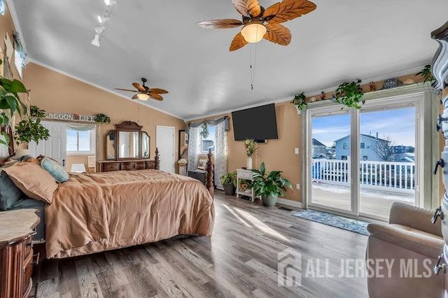 bedroom with ceiling fan, access to outside, wood-type flooring, and lofted ceiling