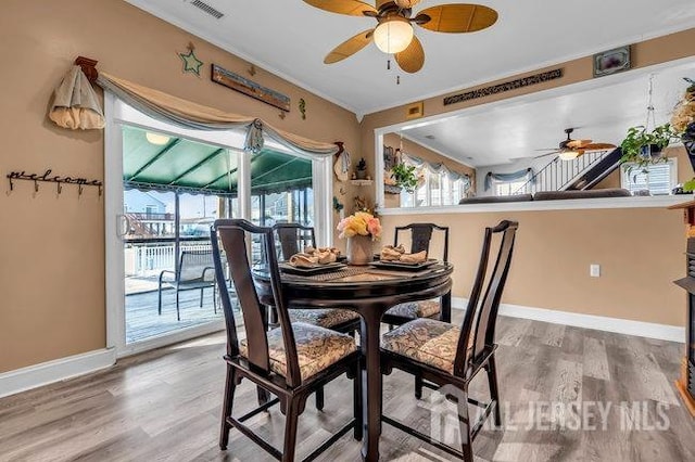 dining area featuring hardwood / wood-style flooring and ceiling fan