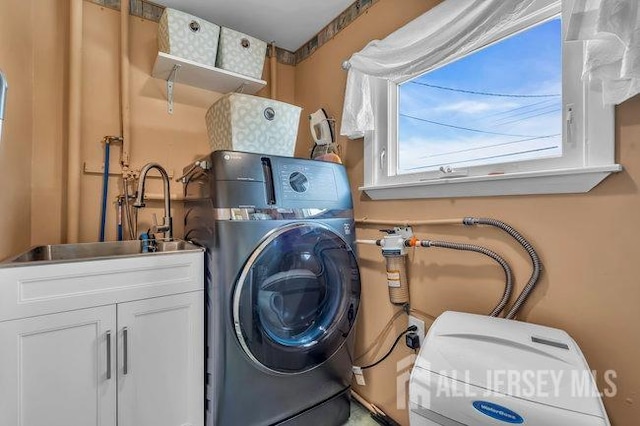 washroom featuring washing machine and clothes dryer and sink