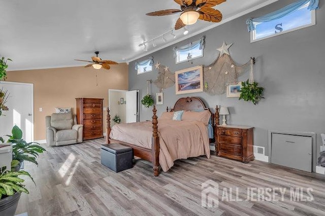 bedroom featuring ceiling fan, light hardwood / wood-style flooring, and crown molding