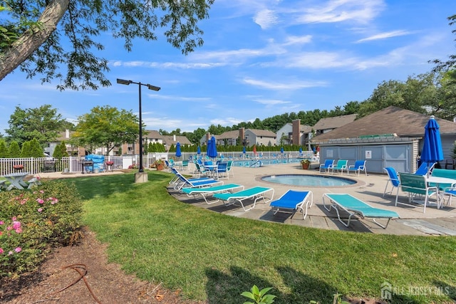 surrounding community featuring a pool, a patio area, fence, and a lawn