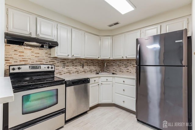 kitchen featuring sink, appliances with stainless steel finishes, white cabinetry, and tasteful backsplash