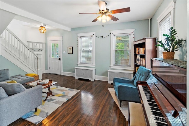 living area with ceiling fan, stairway, healthy amount of natural light, and hardwood / wood-style flooring