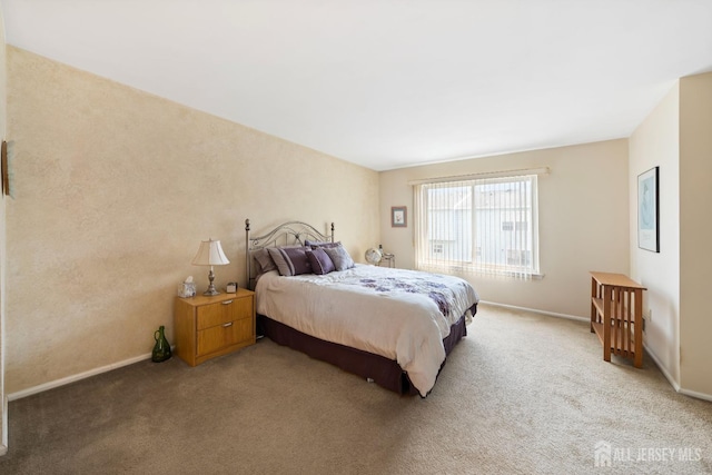 bedroom featuring baseboards and carpet flooring