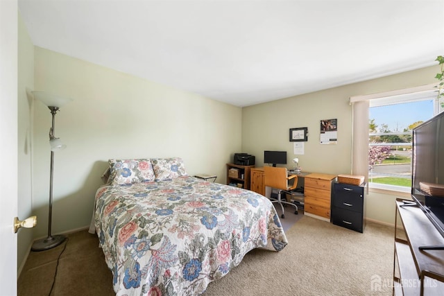 bedroom featuring light carpet and baseboards