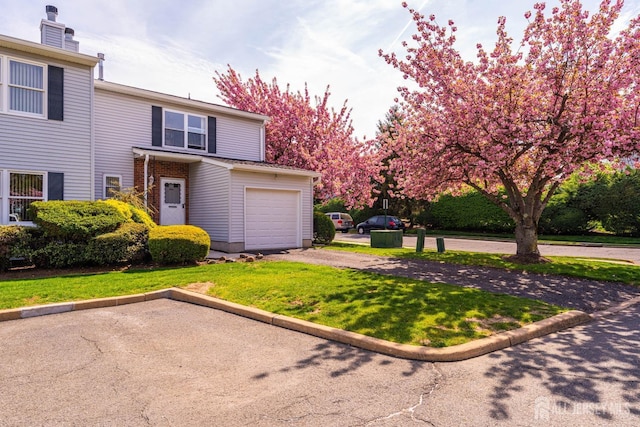 view of front of home with a front lawn and aphalt driveway