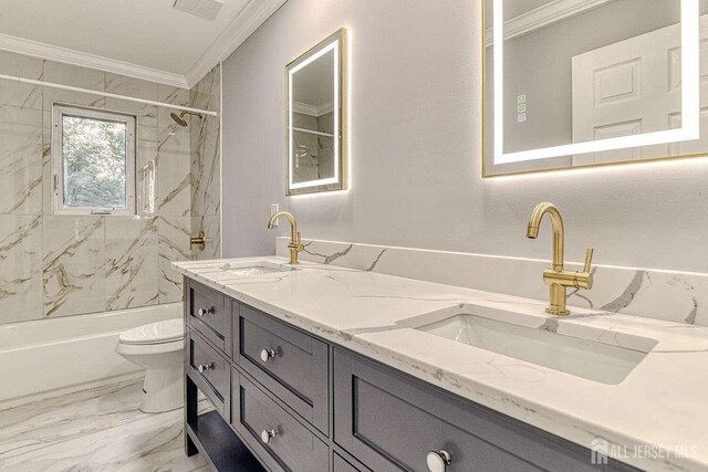 full bathroom with tiled shower / bath combo, vanity, toilet, and crown molding