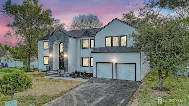 view of front of property with a lawn and a garage