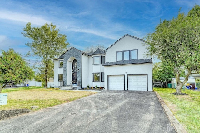 view of front of house with a front yard and a garage