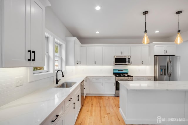 709 Plainfield Ave, Piscataway, NJ 08854 - kitchen with appliances with stainless steel finishes, white cabinets, hanging light fixtures, light stone countertops, and recessed lighting