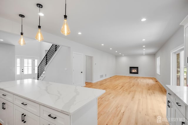 709 Plainfield Ave, Piscataway, NJ 08854 - kitchen featuring open floor plan, white cabinets, light wood-style floors, decorative light fixtures, and recessed lighting