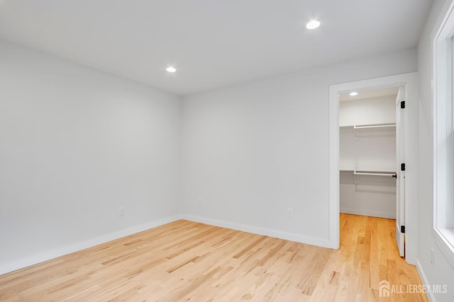 709 Plainfield Ave, Piscataway, NJ 08854 - unfurnished bedroom featuring a spacious closet, wood finished floors, and recessed lighting
