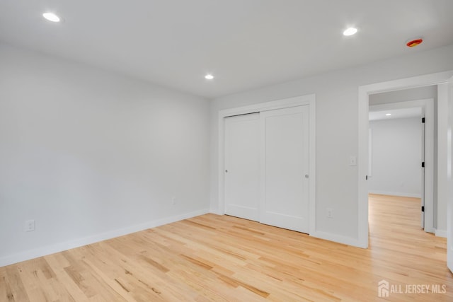 709 Plainfield Ave, Piscataway, NJ 08854 - unfurnished bedroom with wood finished floors, recessed lighting, and a closet