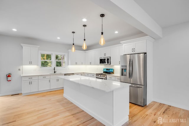 709 Plainfield Ave, Piscataway, NJ 08854 - kitchen featuring appliances with stainless steel finishes, white cabinets, a kitchen island, light wood-style flooring, and recessed lighting