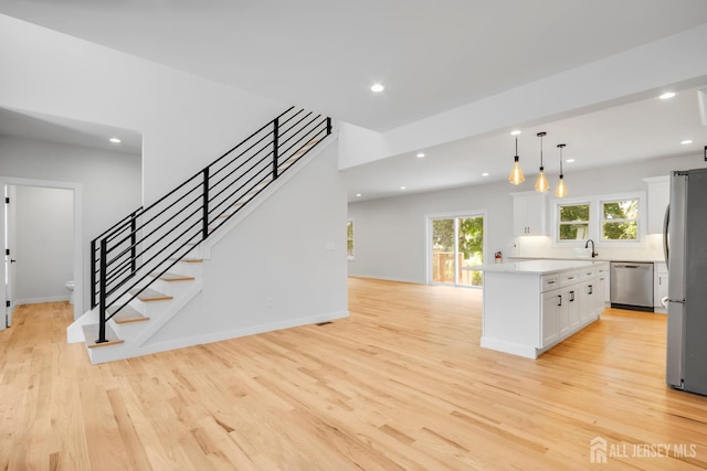 709 Plainfield Ave, Piscataway, NJ 08854 - kitchen with appliances with stainless steel finishes, light wood-style flooring, white cabinetry, recessed lighting, and light countertops