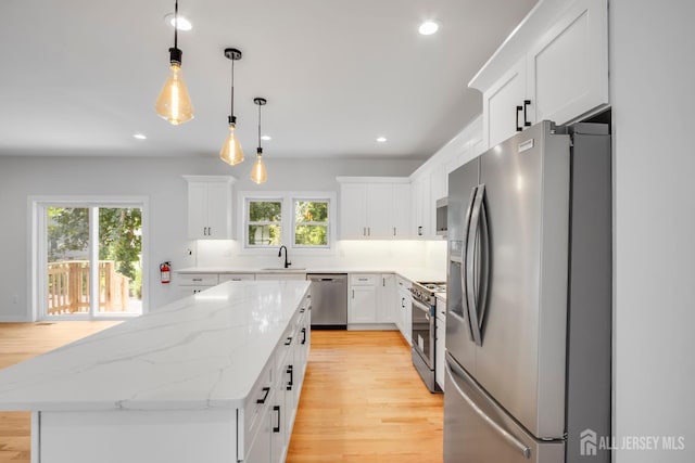 709 Plainfield Ave, Piscataway, NJ 08854 - kitchen with appliances with stainless steel finishes, light wood-style floors, a kitchen island, white cabinets, and recessed lighting