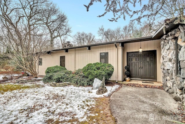 view of snow covered property entrance