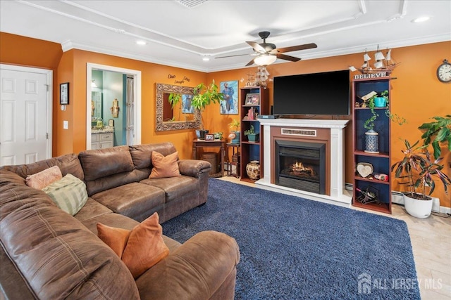 living room with ceiling fan and ornamental molding