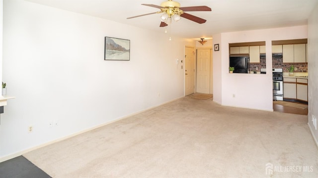 unfurnished living room with ceiling fan and carpet floors