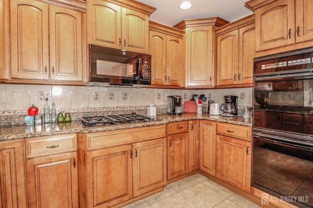 89 King St, Edison, NJ 08820 - kitchen with black appliances, light stone countertops, decorative backsplash, light tile patterned flooring, and recessed lighting
