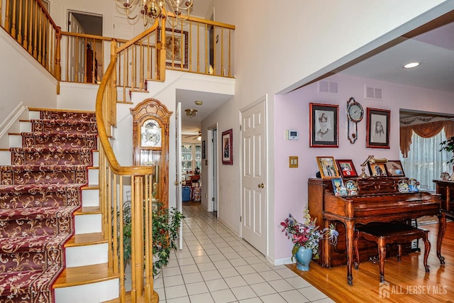 89 King St, Edison, NJ 08820 - stairs featuring tile patterned flooring, a high ceiling, and recessed lighting