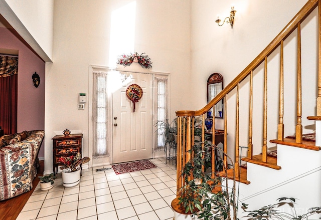 89 King St, Edison, NJ 08820 - foyer featuring a towering ceiling, stairs, light tile patterned floors, and plenty of natural light