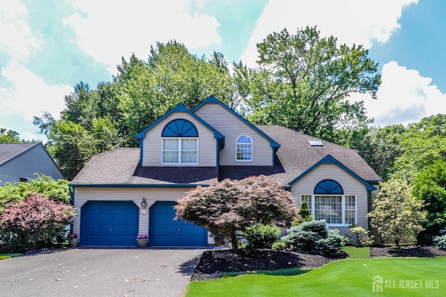 89 King St, Edison, NJ 08820 - view of front of property with asphalt driveway, roof with shingles, a front yard, and a garage