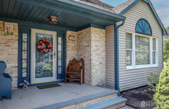 89 King St, Edison, NJ 08820 - doorway to property featuring brick siding and covered porch